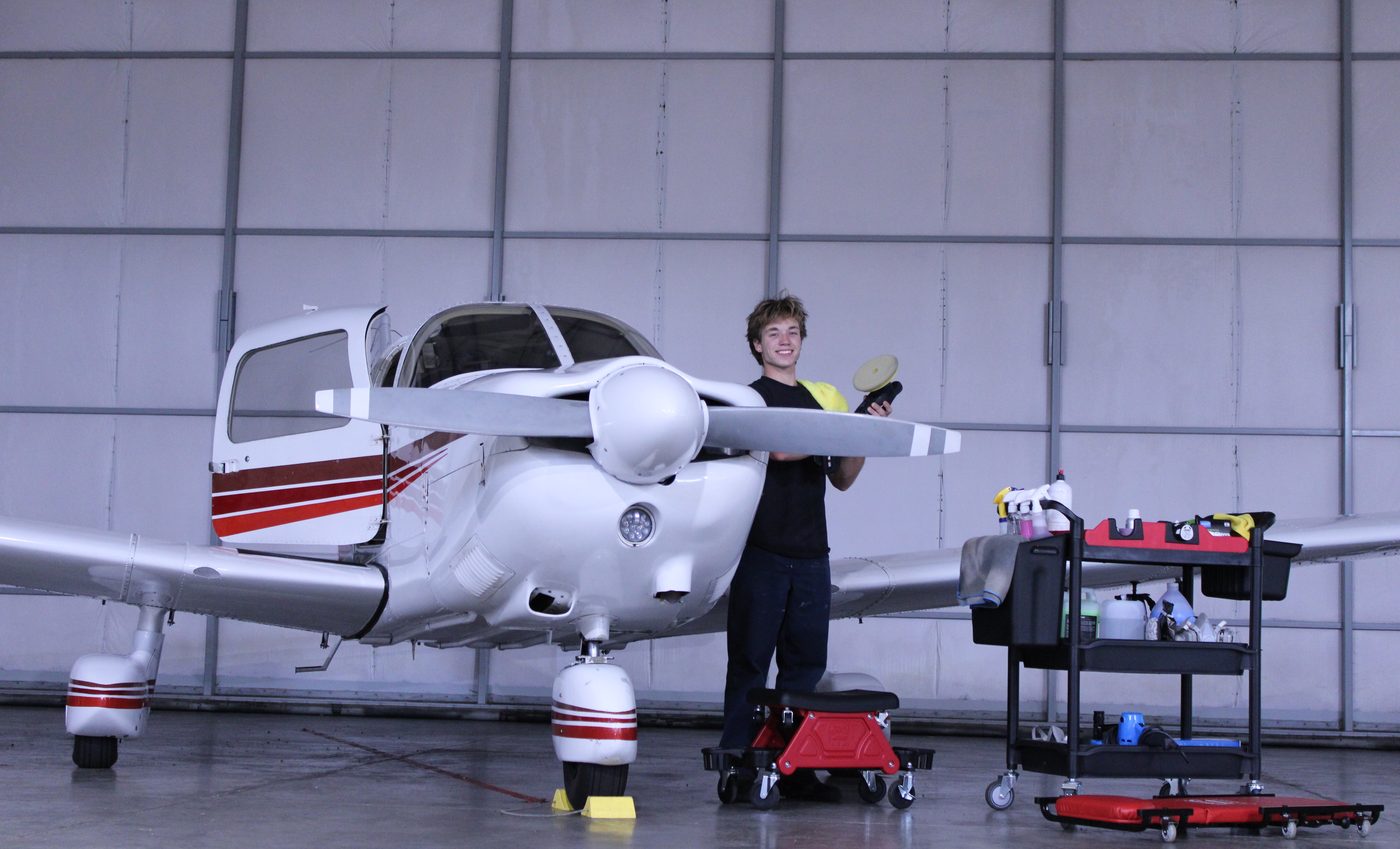 Olga Detailing Services owner detailing a customer's aircraft in a hangar on Orcas Island