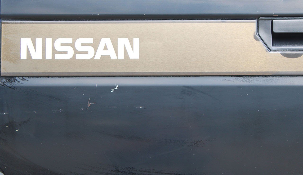 Same Nissan tailgate after detailing, clean and glossy